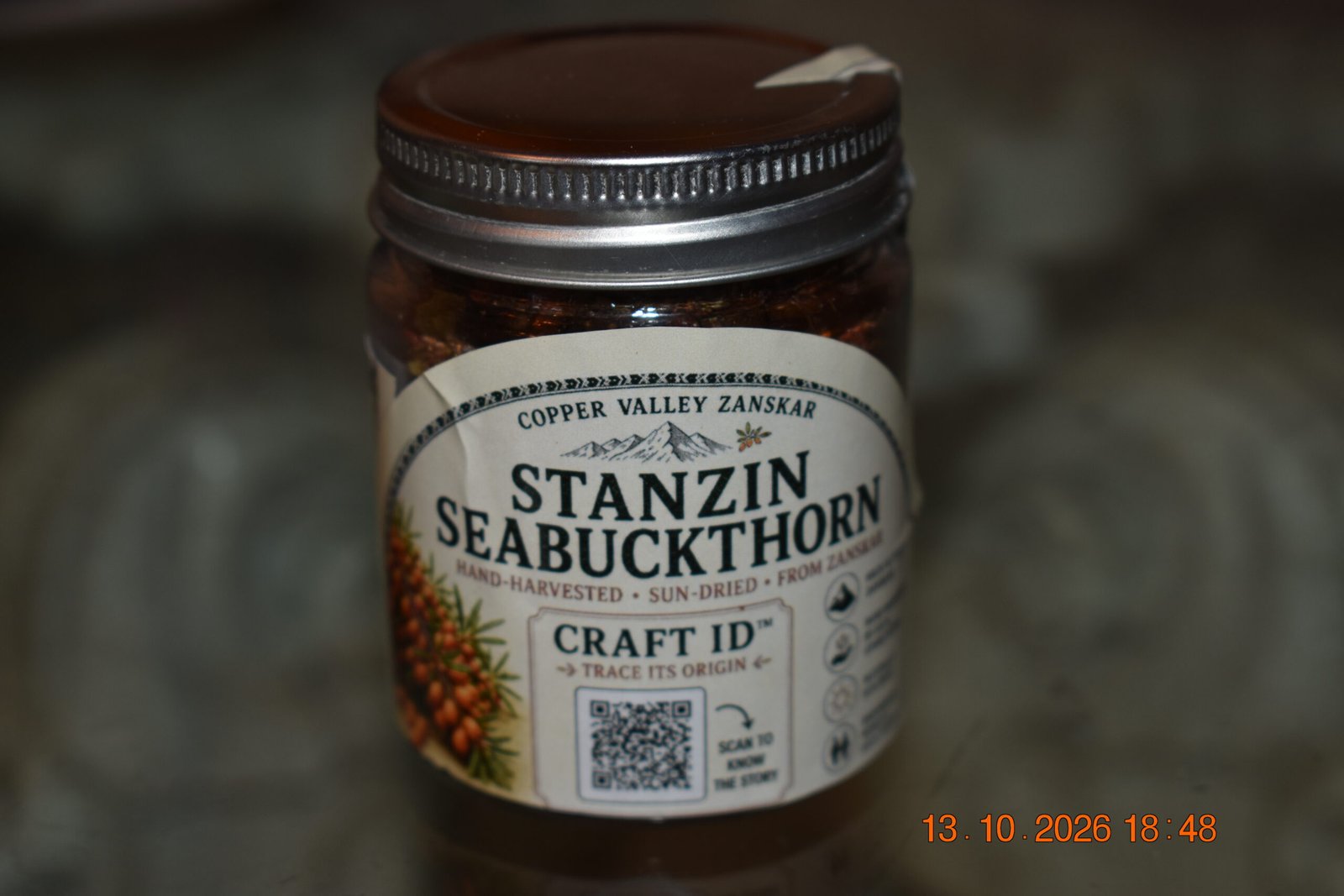 Whole dried seabuckthorn berries in a Copper Valley jar, front view