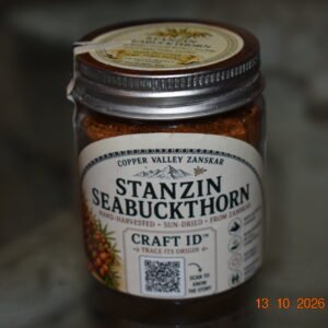 Ground seabuckthorn berry powder in a Copper Valley jar, front view